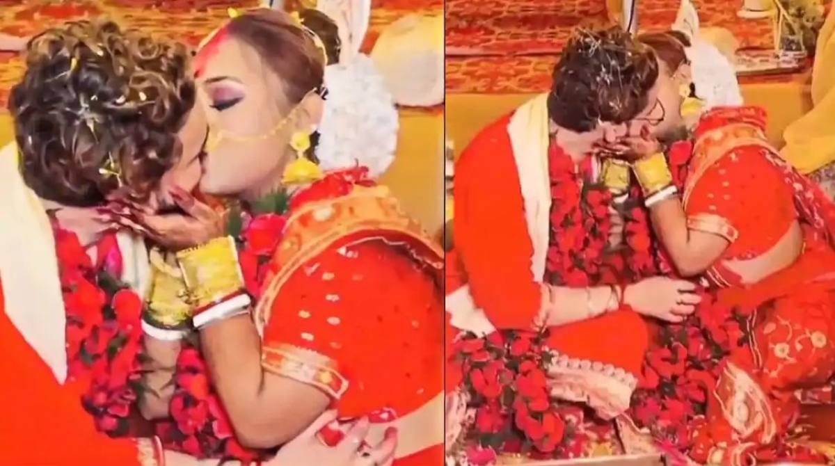 A video of an Indian couple sharing a passionate kiss during wedding